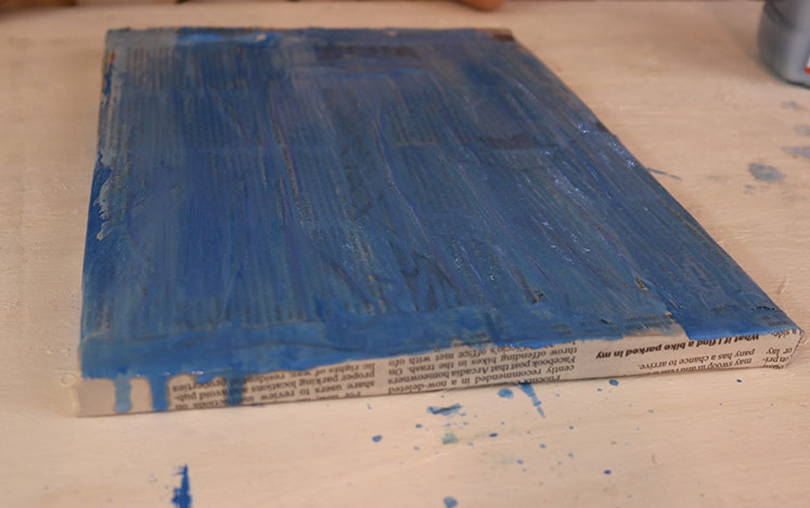 brush-paint-blue-background-newspaper-art